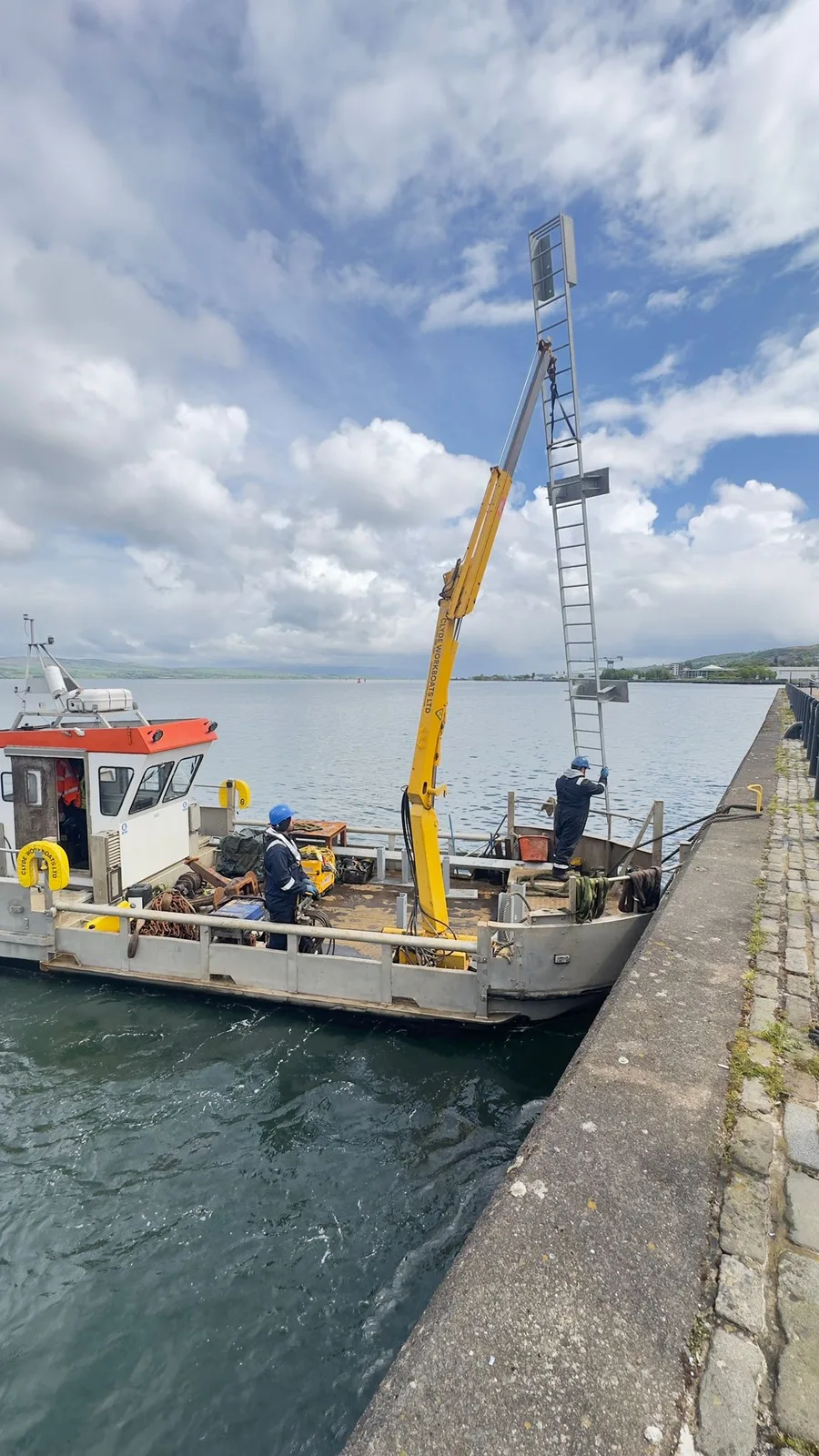 Clyde Workboats Multicat lifting navigation infrastructure beside a quay